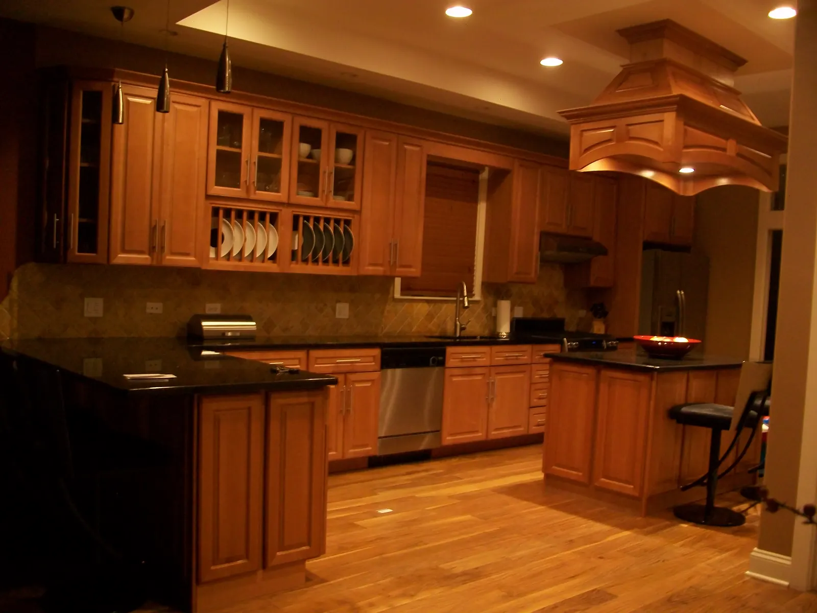 Custom kitchen with a statement range hood built by Ascenso